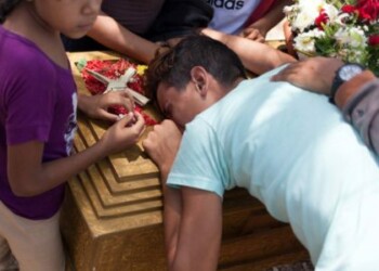 Los deudos lloran junto al ataúd de José Rivero, uno de los presos que murió durante un motín y un incendio en las celdas del Comando General de la Policía de Carabobo, durante su funeral en el cementerio de Valencia, Venezuela el 30 de marzo de 2018. REUTERS / Adriana Loureiro