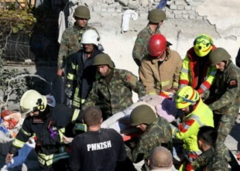 EDITORS NOTE: Graphic content / Emergency workers carry an injured woman from the debris at a damaged building in Thumane, 34 kilometres (about 20 miles) northwest of capital Tirana, after an earthquake hit Albania, on November 26, 2019. - Eight people died and some 150 were slightly injured in Albania after a 6.4 magnitude earthquake, the strongest in decades, rocked the Balkan country early Tuesday. The epicentre of the quake was about 34 kilometres (about 20 miles) northwest of Tirana, according to the European-Mediterranean Seismological Centre. (Photo by Gent SHKULLAKU / AFP)