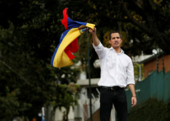 Venezuelan opposition leader Juan Guaido, who many nations have recognised as the country's rightful interim ruler, waves the Venezuelan flag as he speaks to supporters near Bolivia's embassy in Caracas, Venezuela, November 16, 2019. REUTERS/Carlos Garcia Rawlins