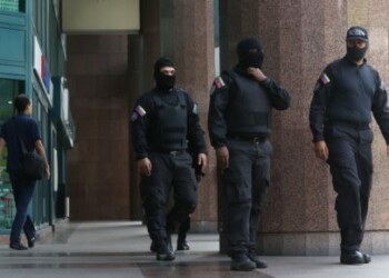 JJPANA9817. CARACAS (VENEZUELA), 21/01/2020.- Integrantes del Servicio Bolivariano de Inteligencia Nacional (Sebin) caminan afuera de la oficina del líder opositor venezolano Juan Guaidó,  a quien casi 60 países reconocen como presidente interino del país, este martes en Caracas (Venezuela). Según pudo constatar Efe, el edificio donde están las oficinas de Guaidó estaba acordonado y en los alrededores se encontraban patrullas del Servicios de Inteligencia (Sebin), que además controlaban la entrada al inmueble, y de un cuerpo de la Policía Nacional Bolivariana (PNB) encargado de la lucha contra la corrupción. EFE/Miguel Gutiérrez