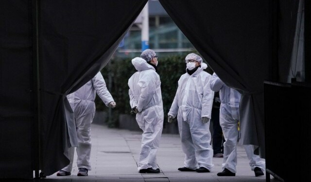 Staff members wearing protective masks are seen at the Shanghai railway station in Shanghai, China, as the country is hit by an outbreak of a new coronavirus, February 7, 2020. REUTERS/Aly Song