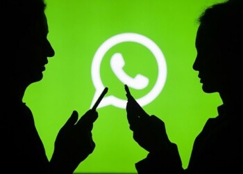 ANKARA, TURKEY - JULY 18 : Silhouettes of people holding mobile phones are seen in front of the logo of WhatsApp application in Ankara, Turkey on July 18, 2018. (Photo by Aytac Unal/Anadolu Agency/Getty Images)