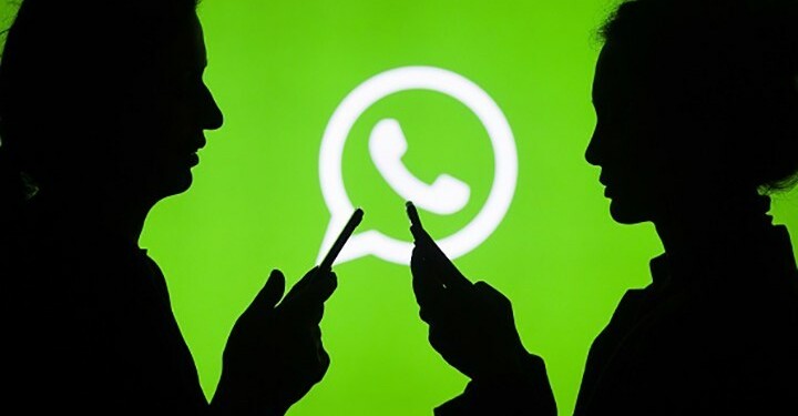 ANKARA, TURKEY - JULY 18 : Silhouettes of people holding mobile phones are seen in front of the logo of WhatsApp application in Ankara, Turkey on July 18, 2018. (Photo by Aytac Unal/Anadolu Agency/Getty Images)