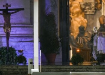 Pope Francis (R) gives the Urbi et Orbi Blessing next to a miraculous crucifix (L) that in 1552 was carried in a procession around Rome to stop the great plague, that was brought from the San Marcello al Corso church in Rome, after presiding over a moment of prayer on the sagrato of St Peterís Basilica, the platform at the top of the steps immediately in front of the faÁade of the Church, on March 27, 2020 at the Vatican. (Photo by Vincenzo PINTO / AFP)