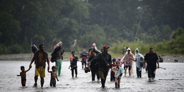 AME1771. DARIÉN (PANAMÁ), 27/09/2023.- Fotografía de archivo fechada el 14 de septiembre de 2023 de migrantes mientras cruzan el río Turquesa, en Darién (Panamá). Panamá supera el umbral de las 400.000 personas llegadas al país a través de la selva del Darién en su viaje irregular hacia Norteamérica, un registro inédito que muestra la magnitud de una creciente crisis migratoria en América que se intenta atajar con más deportaciones. EFE/ Bienvenido Velasco ARCHIVO