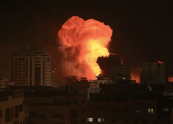 A fireball erupts during Israeli bombardment of Gaza City on October 9, 2023. Israel imposed a total siege on the Gaza Strip on October 9 and cut off the water supply as it kept bombing targets in the crowded Palestinian enclave in response to the Hamas surprise assault it has likened to the 9/11 attacks. (Photo by MAHMUD HAMS / AFP)